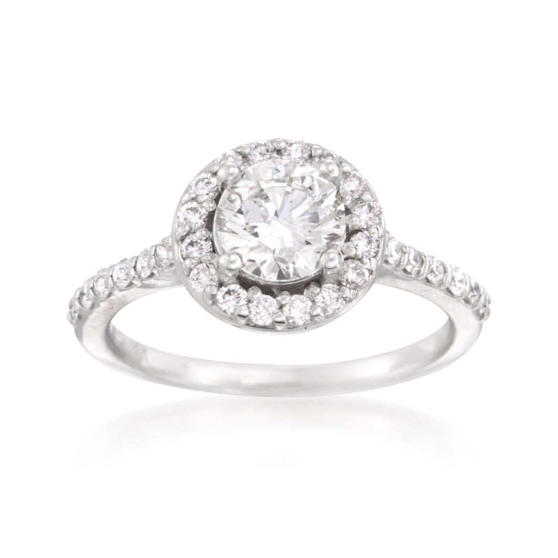 Diamond halo ring in 14kt white gold with round center stone and pavé band