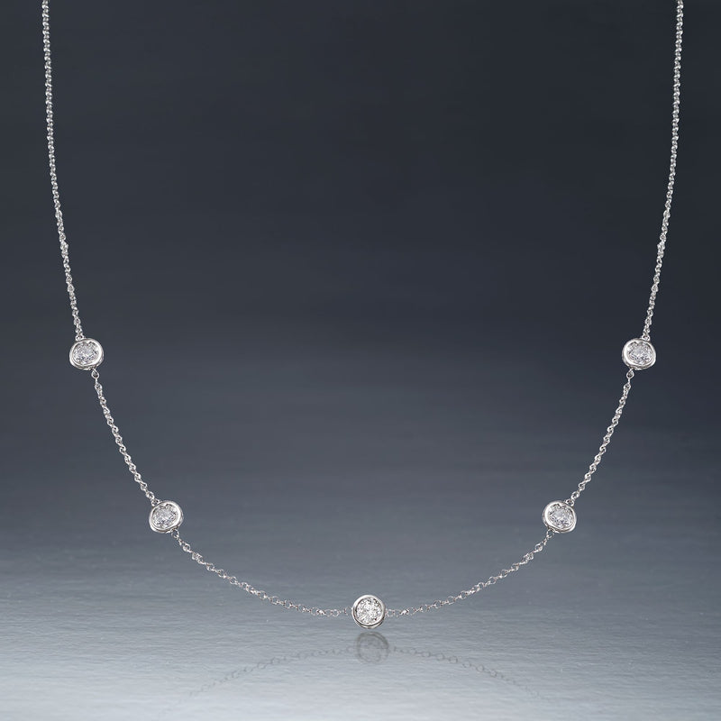 14kt white gold diamond station necklace with five round bezel-set diamonds