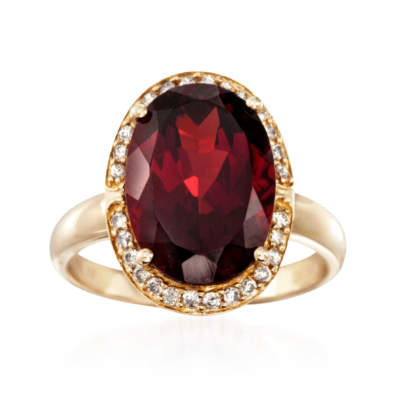 Oval garnet halo ring with diamond accents in 14kt yellow gold