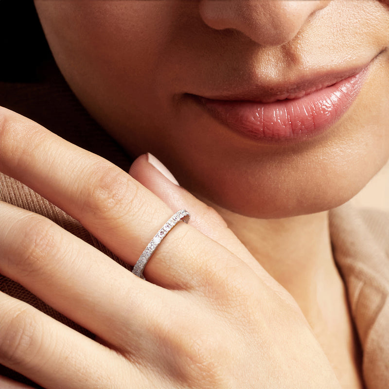 Diamond eternity band in 14kt white gold on a hand
