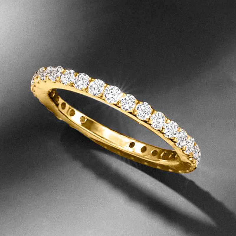 14kt yellow gold diamond eternity band angled view with round diamonds in a row