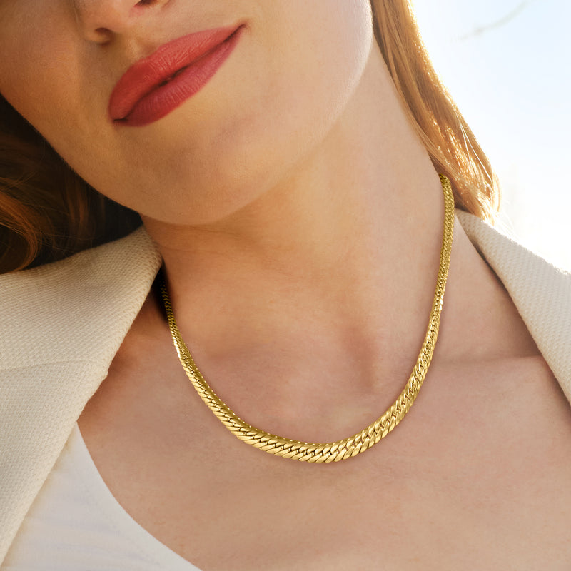 18kt yellow gold graduated Cuban-link necklace worn at the neckline
