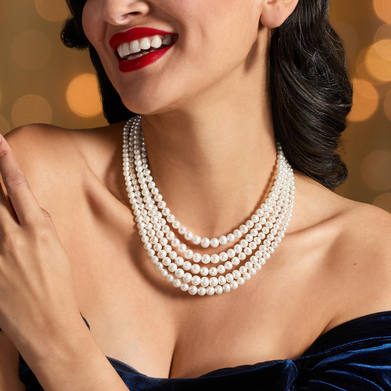 Layered five-strand cultured pearl necklace worn at the neckline