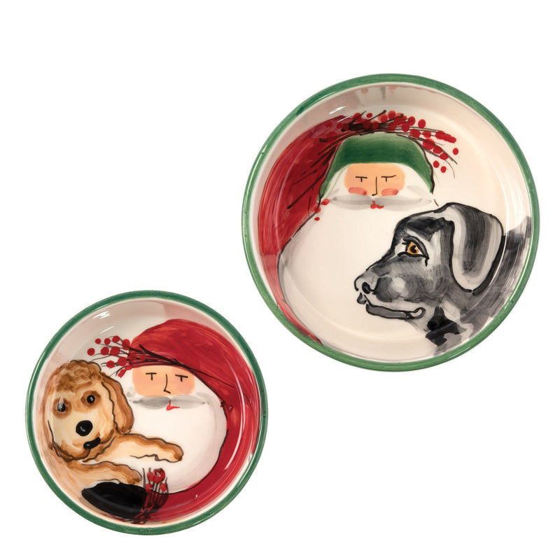 Ceramic dog bowls with green rims, featuring Santa and dog face illustrations