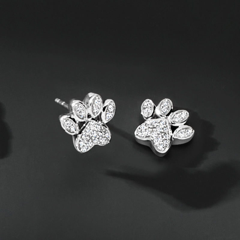 Sterling silver diamond paw print stud earrings, angled view of post and paw details
