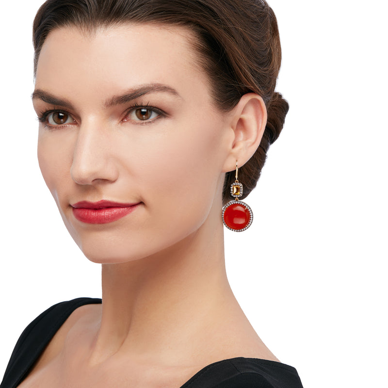 Orange drop earrings with round stone center and crystal halo, worn with earwire