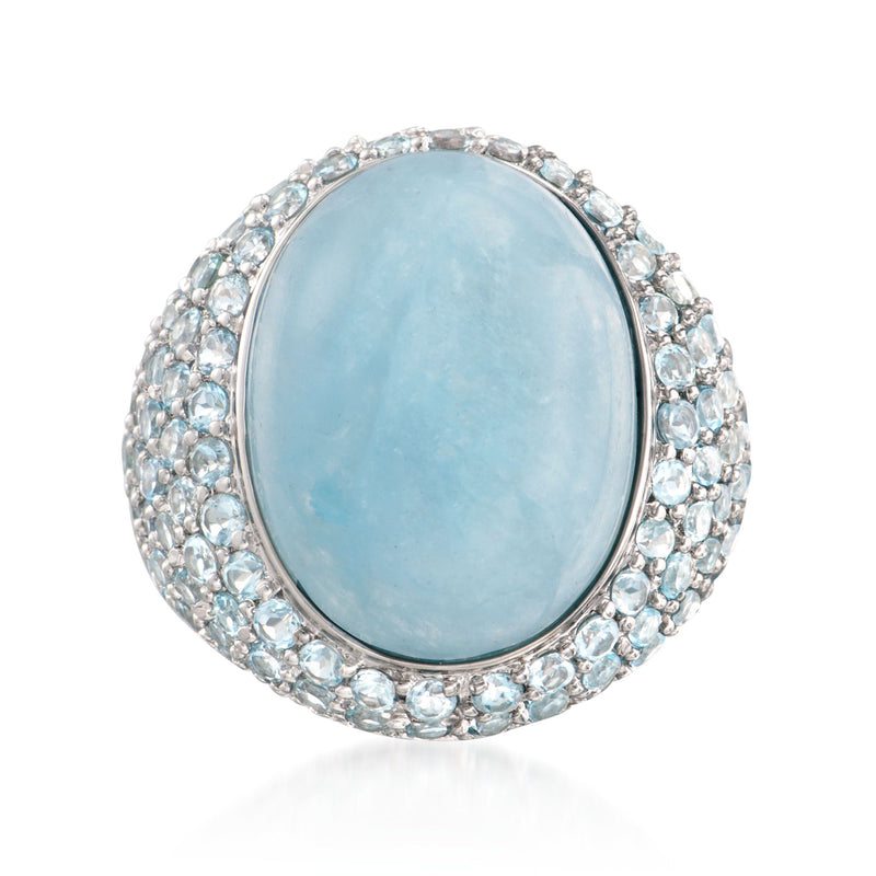 Sterling silver ring with oval sky-blue topaz and jeweled halo