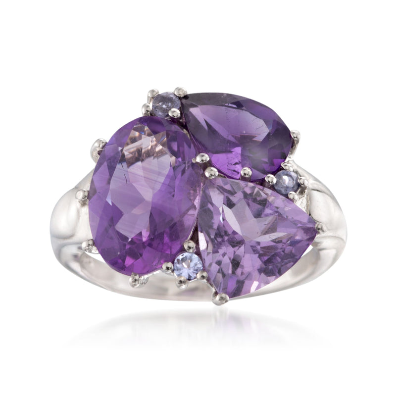 Sterling silver cluster ring with three purple faceted stones and small clear accents