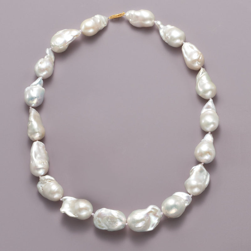 Baroque pearl necklace with 14kt yellow gold clasp and curved row of oval pearls