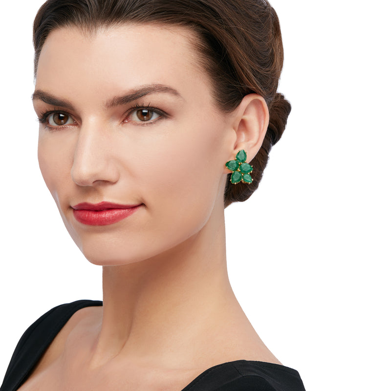 Green gemstone cluster stud earrings with gold-tone setting on model
