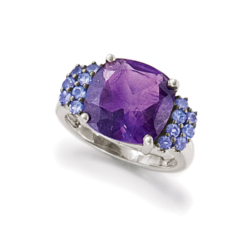 Sterling silver ring showing purple amethyst cushion surrounded by blue gemstones