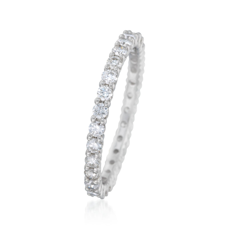 14kt white gold eternity band with round diamond clusters on a slim shank