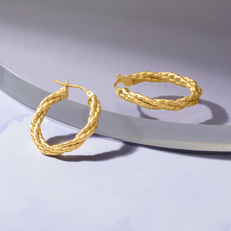 Twisted oval hoop earrings with braided texture, gold tone, hinged post closure.