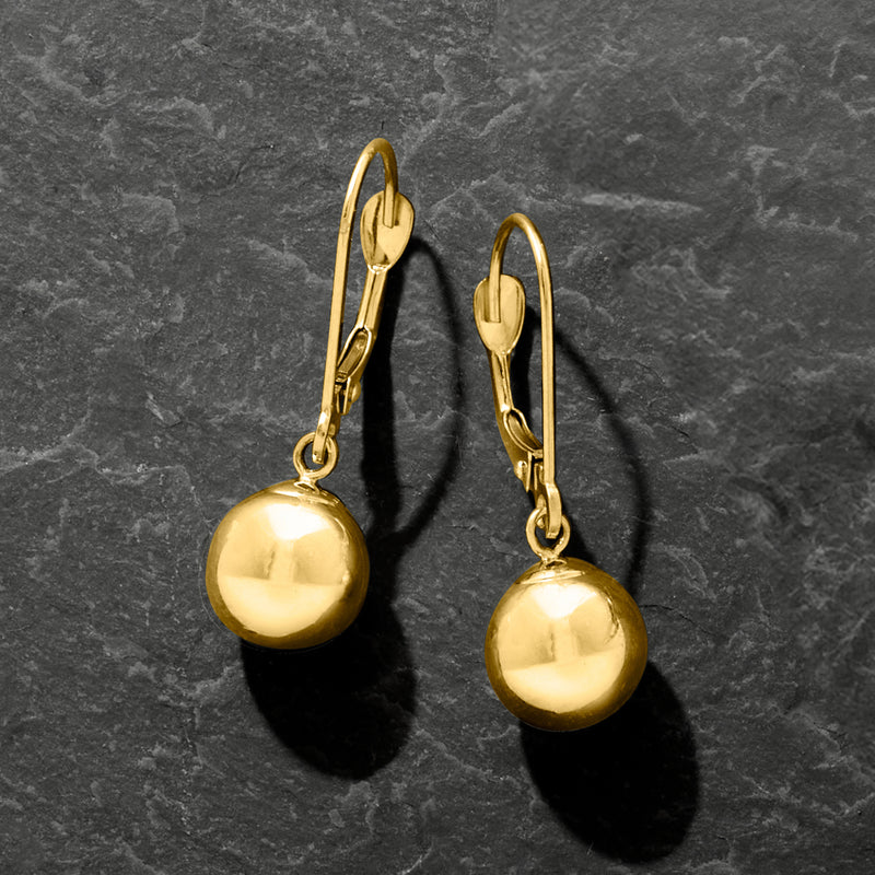Round polished gold bead drop earrings on leverback hooks, side view