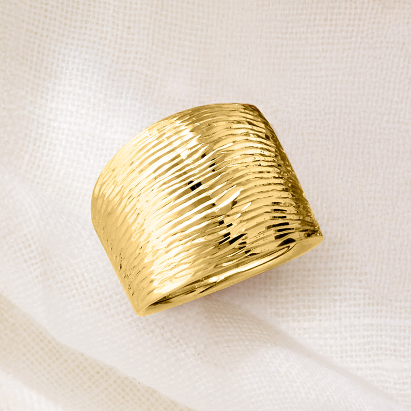 Yellow gold diamond-cut dome ring, close-up angled view of textured top