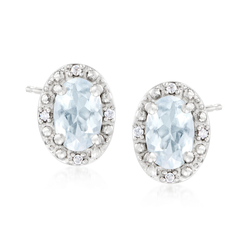 Sterling silver oval aquamarine stud earrings with diamond halo and post backs