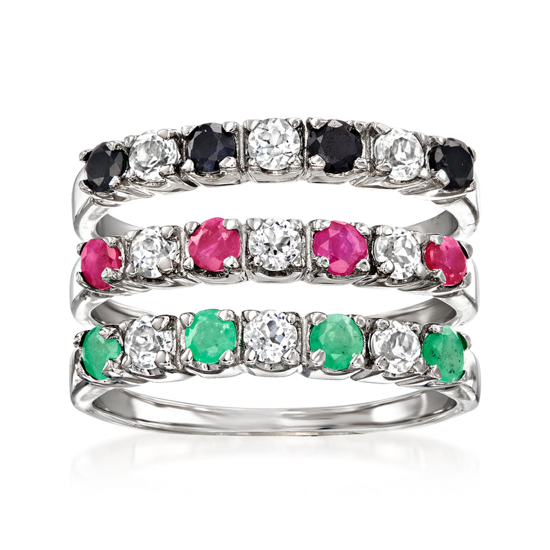 Stackable sterling silver rings with black, clear, pink, and green gemstones