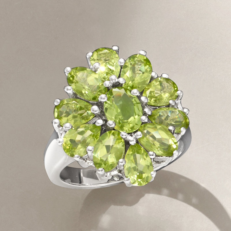 Sterling silver peridot cluster ring with five faceted oval green gemstones in a floral design