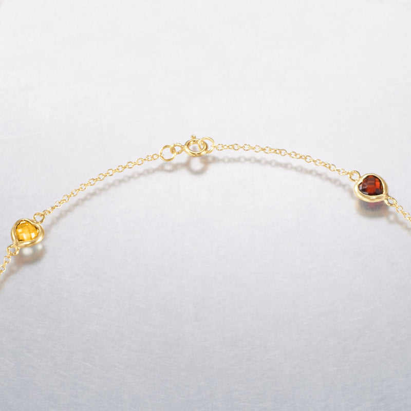 Multi-gemstone station necklace clasp with red round gemstone on gold chain
