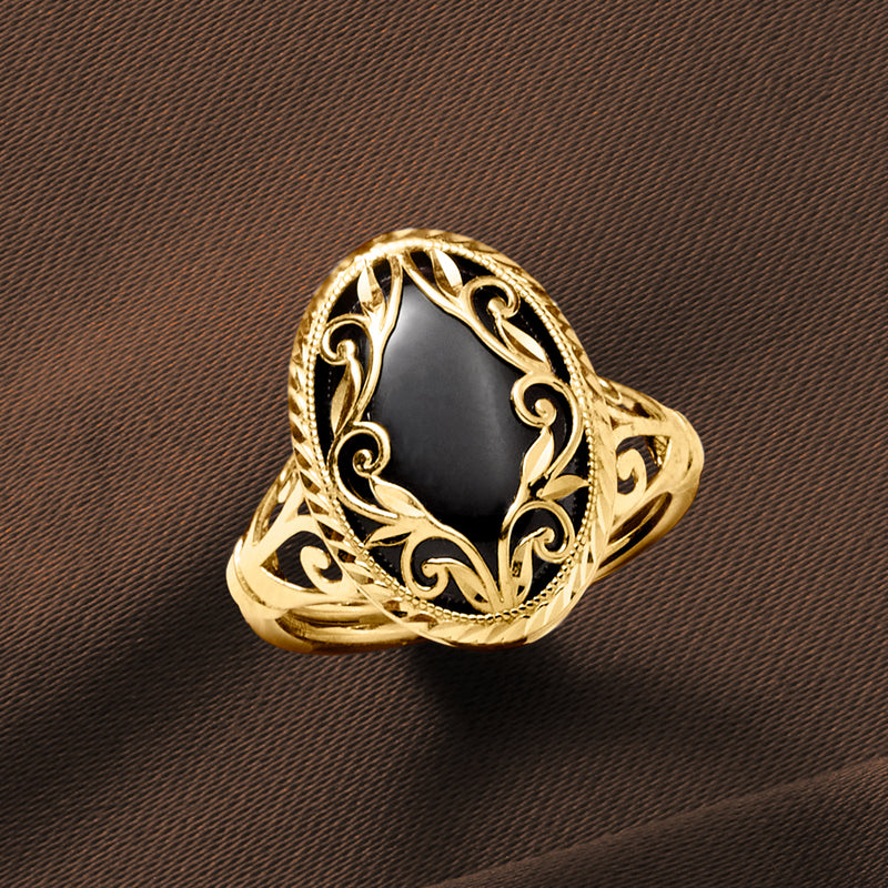 14kt yellow gold onyx scrollwork ring, angled view of oval black stone bezel