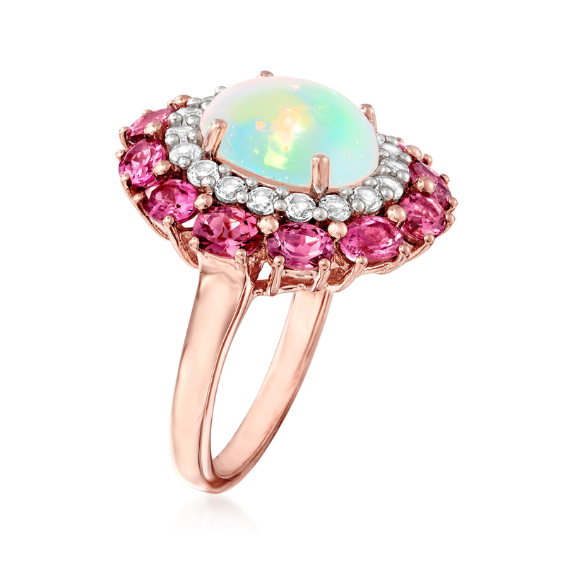 Rose-gold ring with oval opal center, pink side stones, and white halo stones