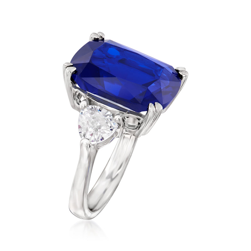 Sterling silver ring with cushion-cut blue gemstone and prong-set clear accent stones