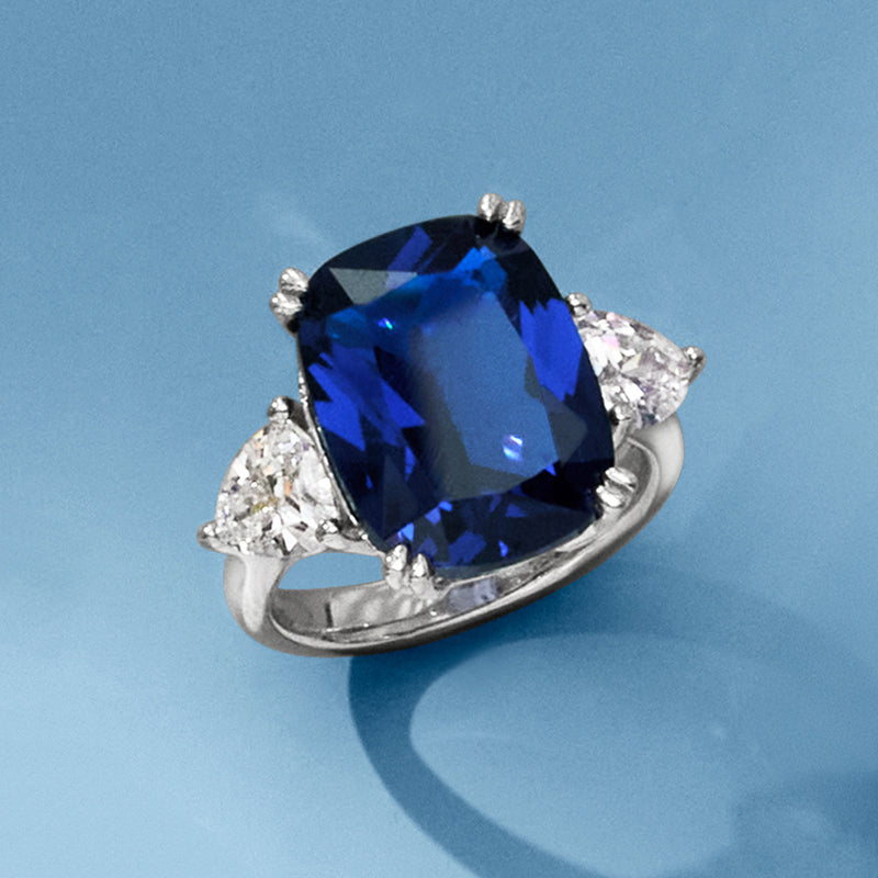 Sterling silver ring with large cushion-cut blue center stone and two triangular clear stones