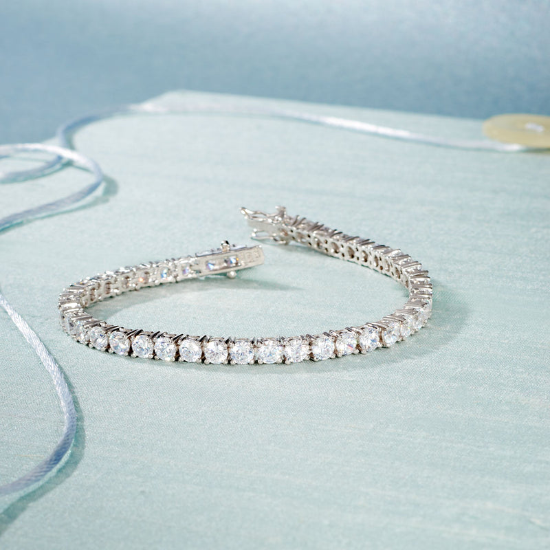 Sterling silver tennis bracelet with bright round CZ stones, hinged clasp visible