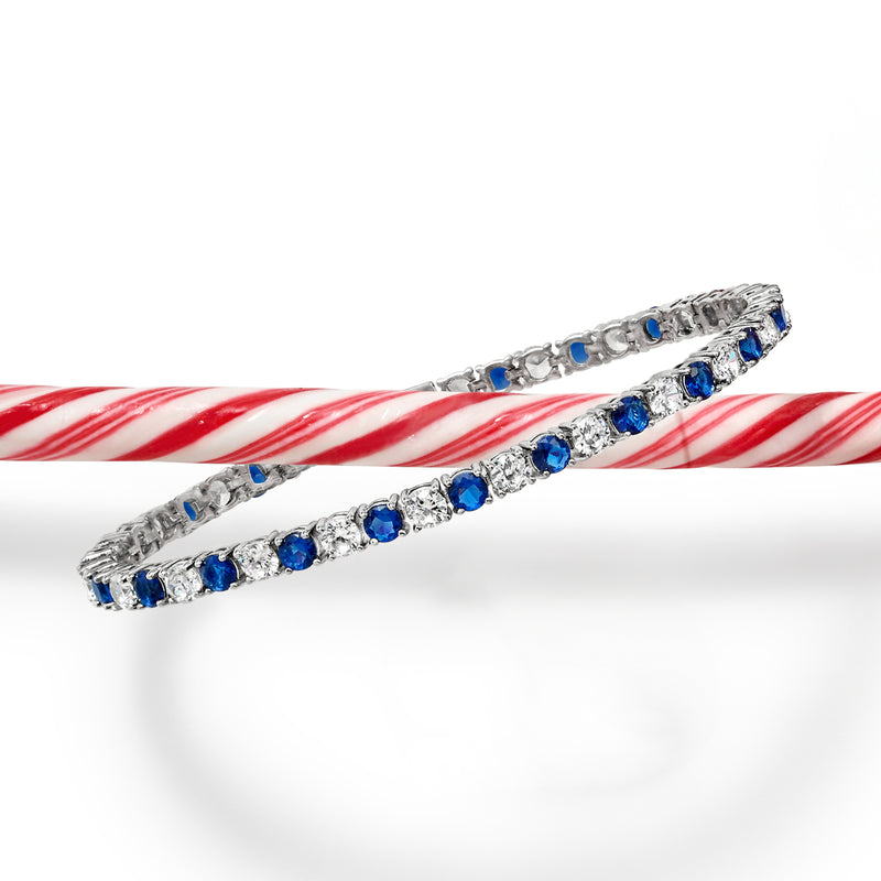 Sterling silver bracelet with blue simulated sapphire stones and clear CZ stones along links