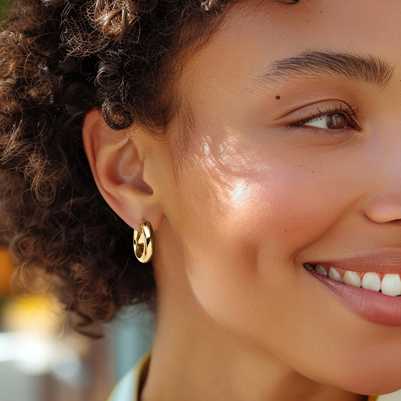 Small yellow gold hoop earrings on person, circular hoop with hinge detail