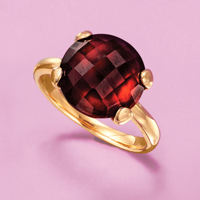 Gold over sterling ring with round dark red faceted garnet, four prongs, curved band