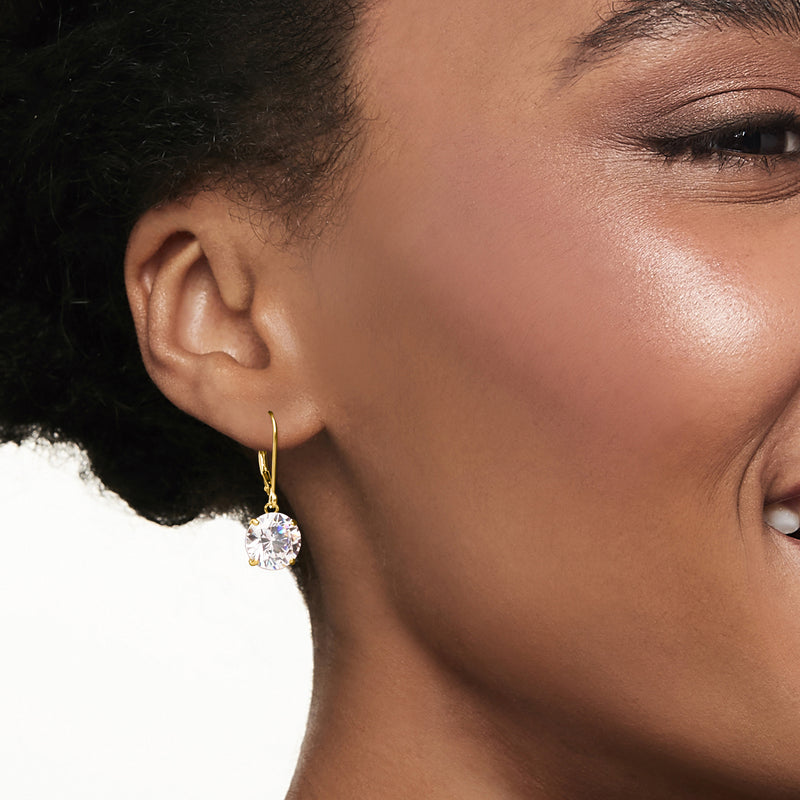 14kt yellow gold CZ drop earrings on ear, small round clear stone dangle