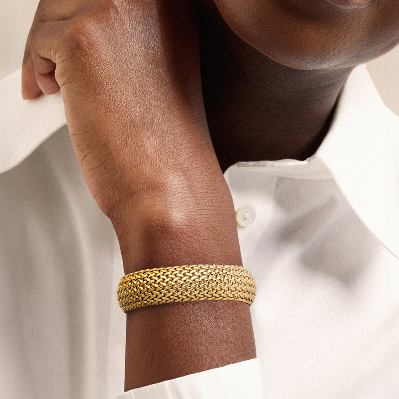 Gold over sterling riso-link bracelet worn on wrist, textured mesh band
