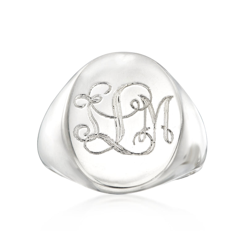 Silver signet ring with engraved monogram design on rounded face