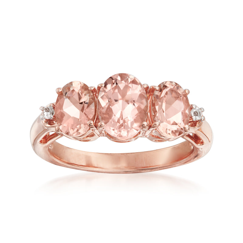 Rose gold morganite ring with three oval pink gemstones and small white accents