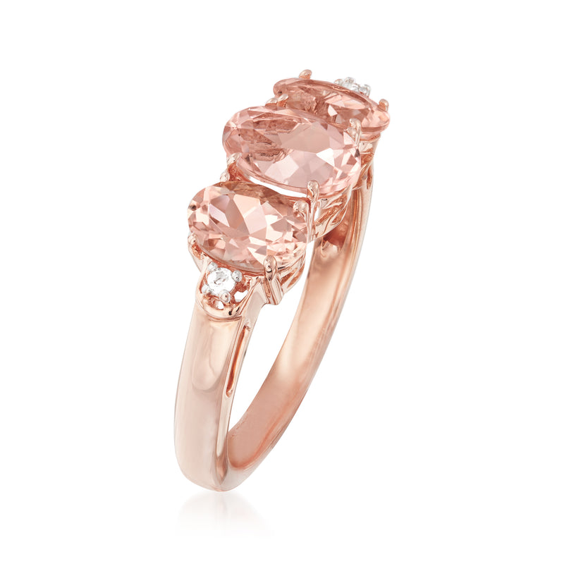 Rose gold morganite ring side view with prong-set oval pink gemstones and white accents