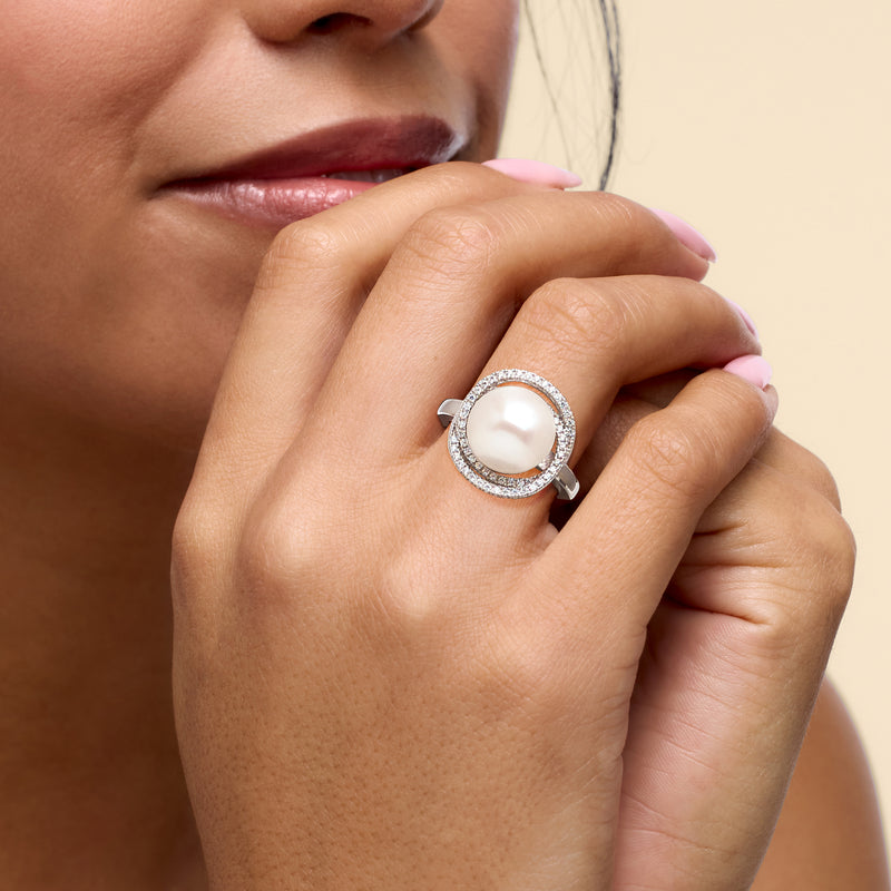 Sterling silver cultured pearl ring with CZ halo on model's hand