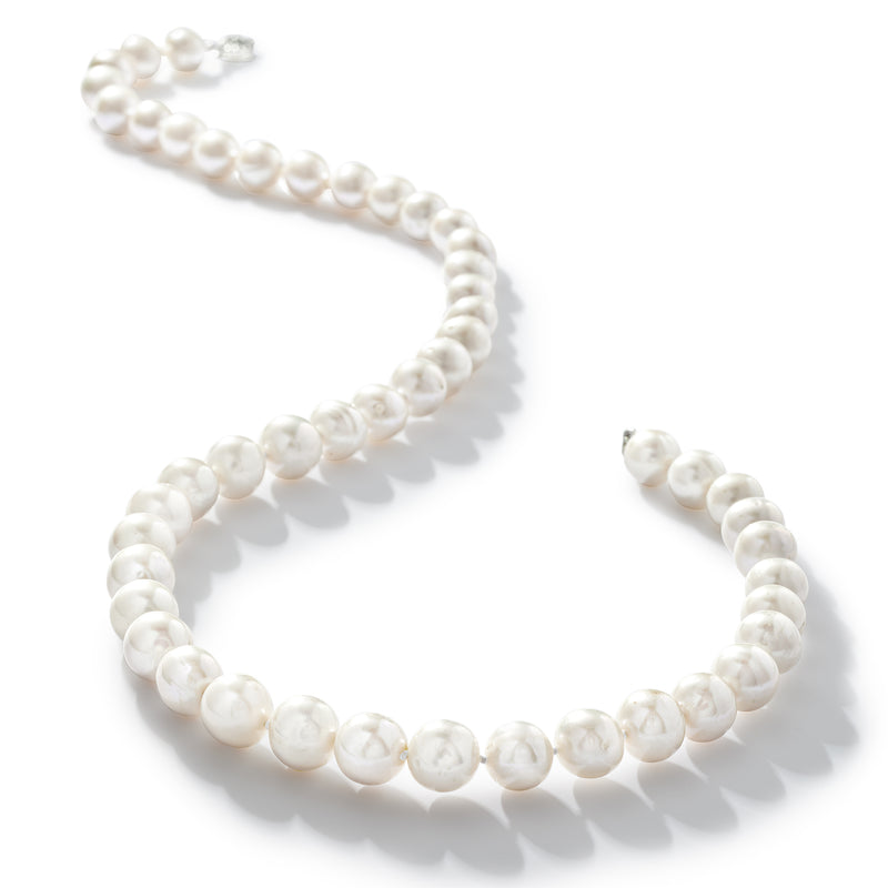 Cultured pearl necklace laid flat, round white pearls in a single strand