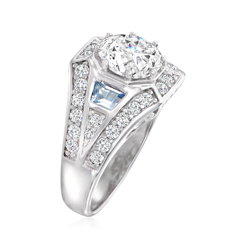 Sterling silver ring with round clear CZ center, blue simulated aquamarine side stone, halo