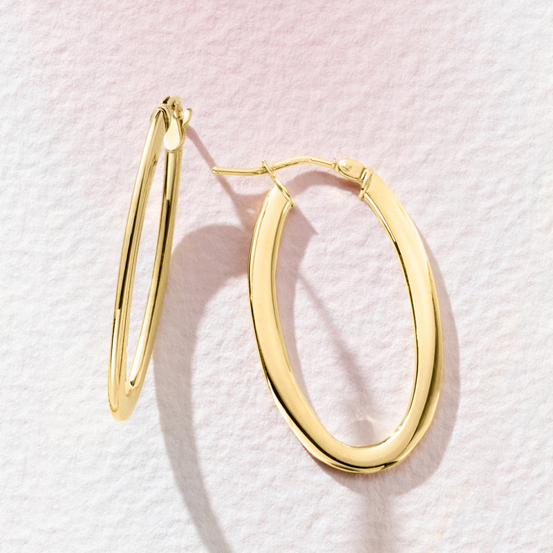 14kt yellow gold oval hoop earrings, angled view, hinged closure with posts