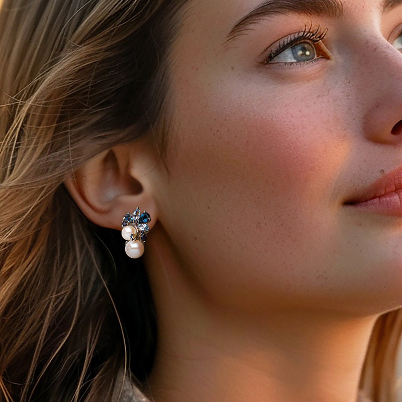 Sterling silver pearl stud earrings with blue gemstone clusters on side profile