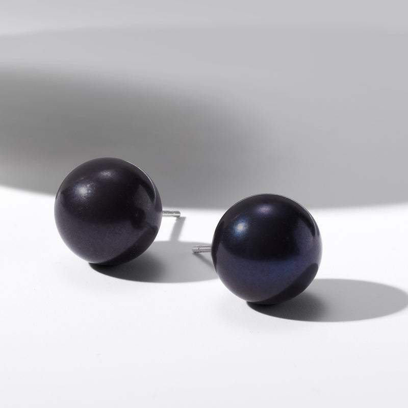 Round black cultured pearl stud earrings with metal posts, side view