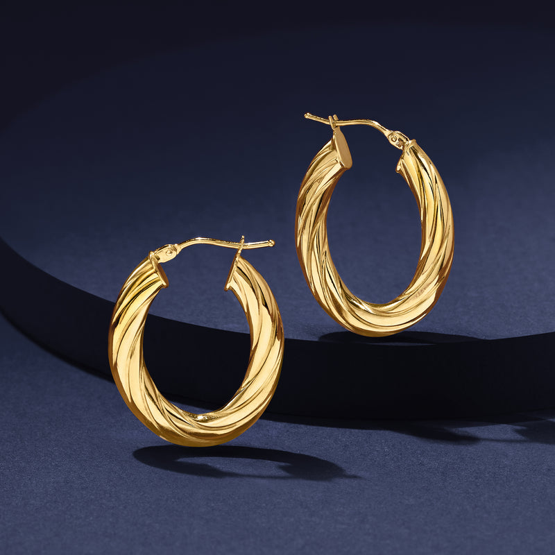 Yellow gold oval hoop earrings, ribbed double-loop design with hinge closure