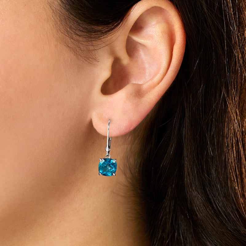 London blue topaz drop earrings on ear, sterling silver leverback closure