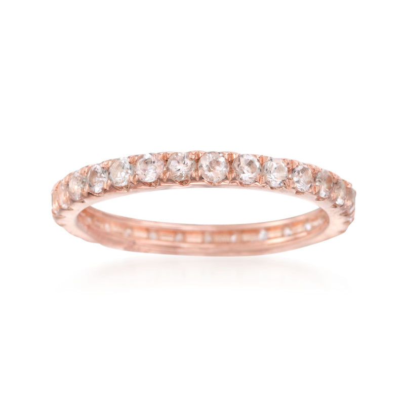 Rose gold eternity band with round morganite-like gemstones along the top