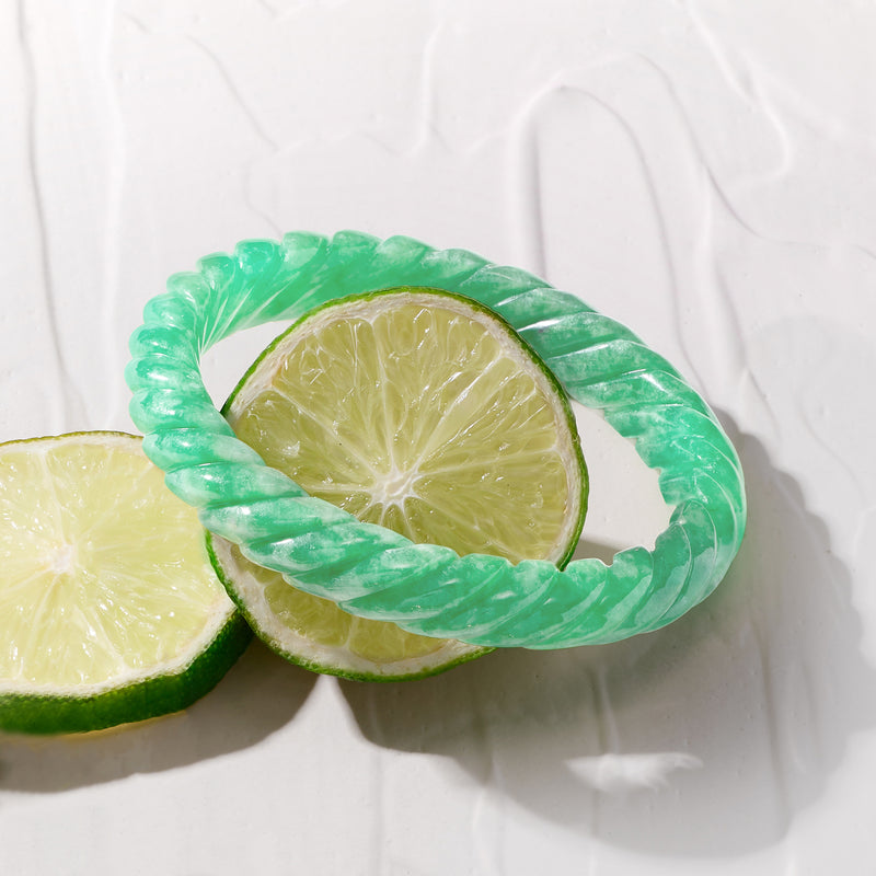 Carved jade bangle bracelet with glossy light-green carved texture