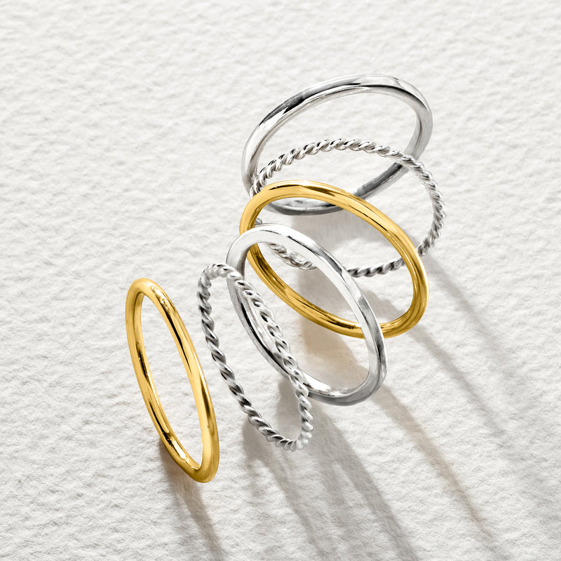 Stackable rings with braided rope detailing in silver and gold over sterling