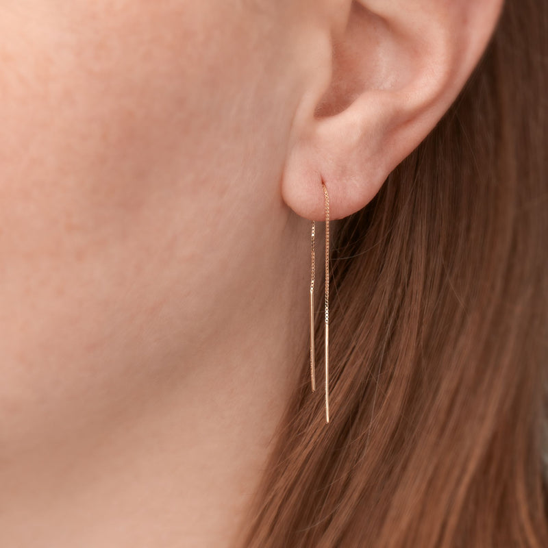 14kt yellow gold threader bar drop earrings on model ear