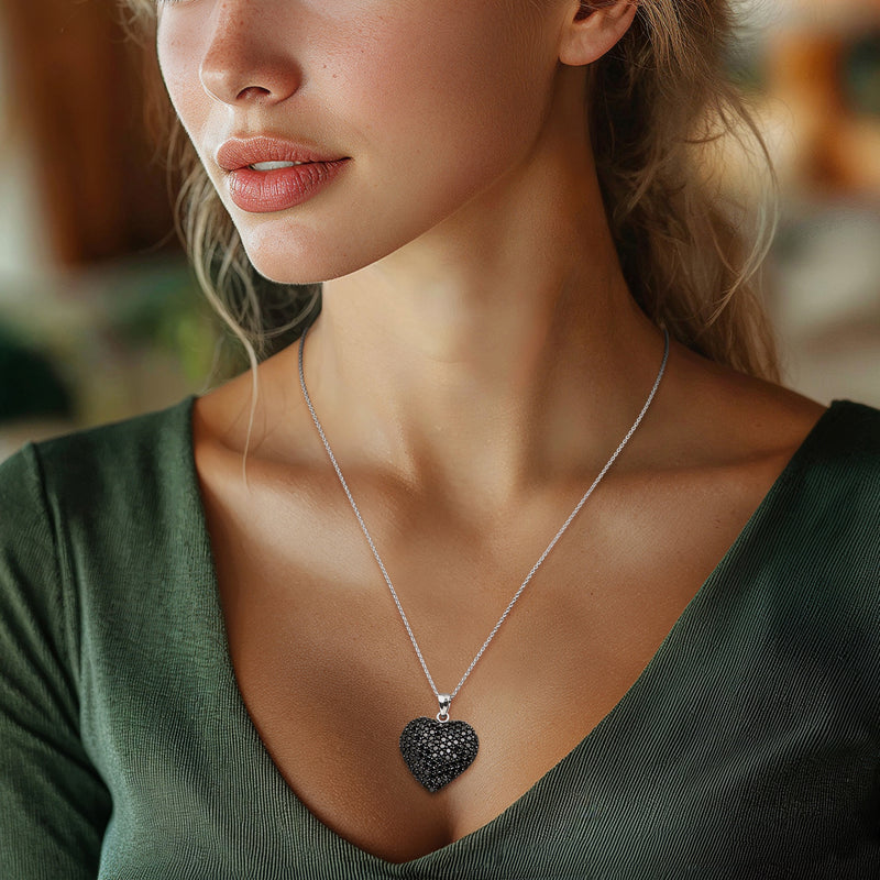 Sterling silver heart pendant necklace with black pave stones, worn at neckline