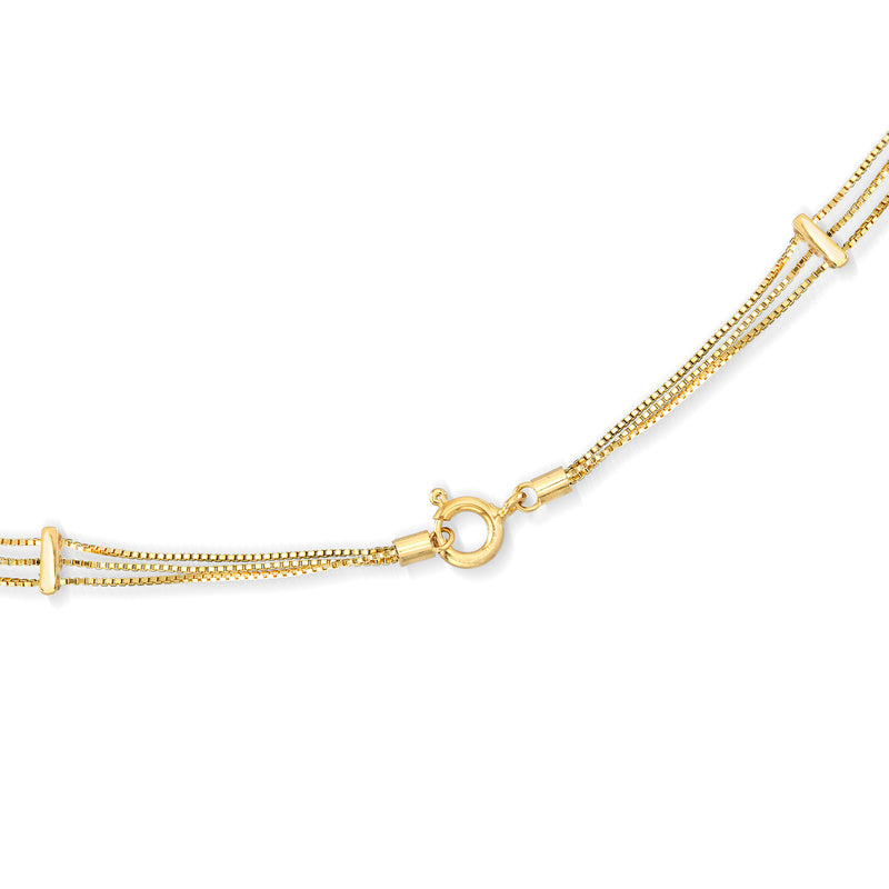 Three-strand pearl necklace with round white pearls and 18kt gold clasp detail